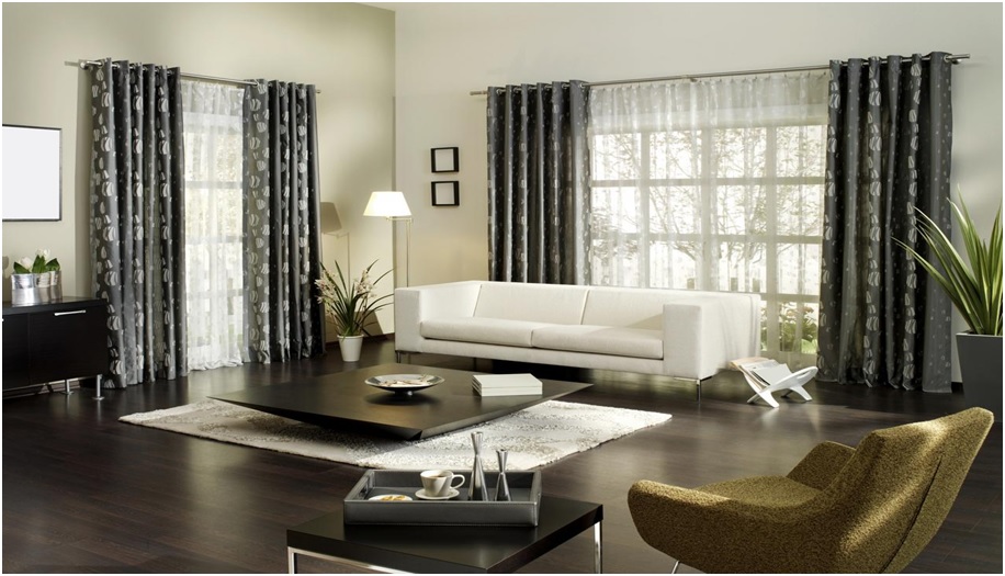 Modern living room with white sofa and dark curtains.
