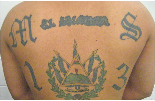 Tattoo of Guatemalan emblem with flags on skin.
